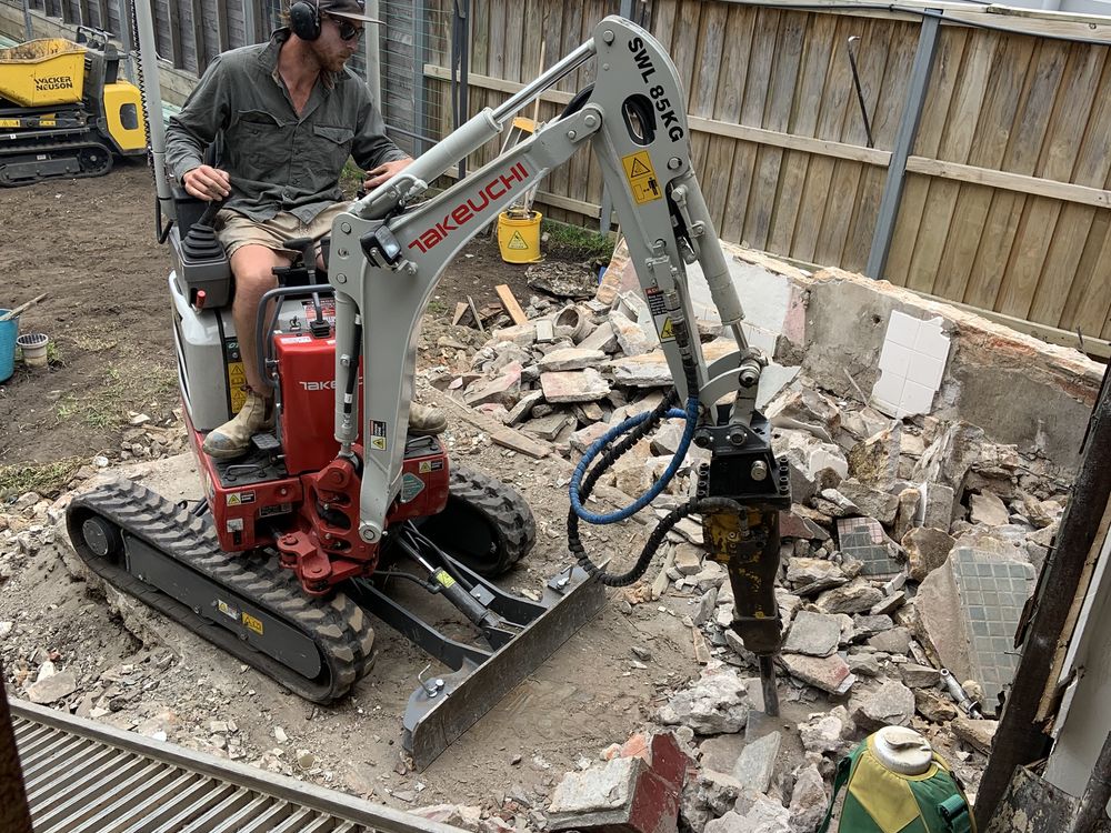 Auger post hole digging along a timber fence line